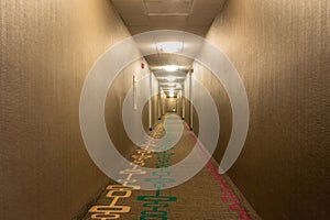 Empty Hotel Corridor Lit with Lighting Fixtures