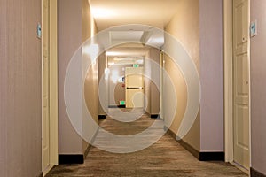Empty hotel hall with emergency exit in the distance