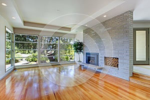 Empty house interior. Living room with glass wall and brick wall