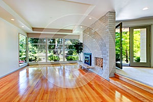 Empty house interior. Living room with glass wall and brick wall