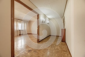 An empty house with a large hall with access to a living room