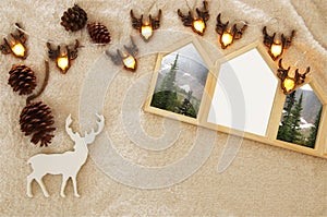 Empty houses shape wooden photo frames over cozy and warm fur carpet. For photography montage. Scandinavian style design