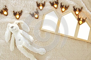Empty houses shape wooden photo frames over cozy and warm fur carpet. For photography montage. Scandinavian style design