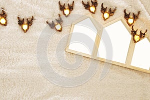 Empty houses shape wooden photo frames over cozy and warm fur carpet. For photography montage. Scandinavian style design