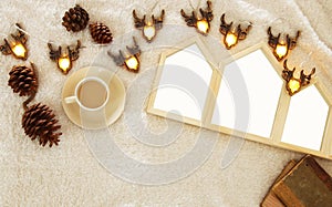 Empty houses shape wooden photo frames over cozy and warm fur carpet. For photography montage. Scandinavian style design