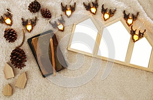 Empty houses shape wooden photo frames over cozy and warm fur carpet. For photography montage. Top view