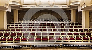 Empty huge hall interior with rows of red chairs