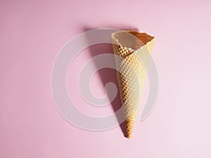 Empty ice cream waffle cup, cone cone on pink background