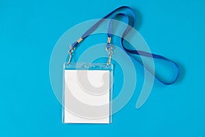 Empty ID card badge icon with blue belt, on blue background.