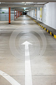 Empty illuminated underground car parking space large area wide angle view no people