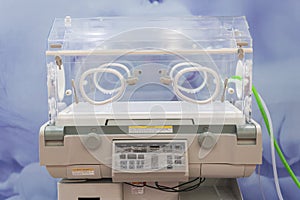 Empty infant incubator in an hospital room. Specially equipped room with newborn babys sleeping in incubators in the Obstetrics photo