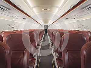 Empty interior cabin of an Airbus A320 Neo with red seats and trim. Many airlines face dire straits as they face a worldwide