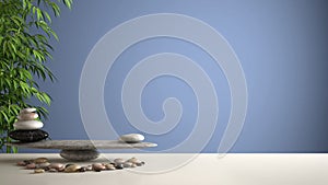 Empty interior design feng shui concept zen idea, white table or shelf with pebble balance and green bamboo, over blue background