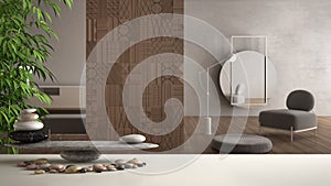 Empty interior design feng shui concept zen idea, white table or shelf with pebble balance and green bamboo, over blurred living