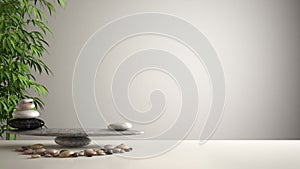 Empty interior design feng shui concept zen idea, white table or shelf with pebble balance and green bamboo, over white blank back