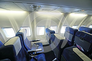 Empty interior of modern airplane with blue seats and no passangers.