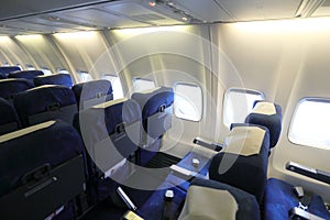 Empty interior of modern airplane with blue seats and no passangers.