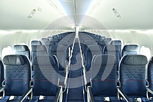 Empty interior of modern airplane Boeing 737-8 Max with blue seats and no passangers.