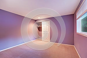 Empty interior of purple room with carpet floor