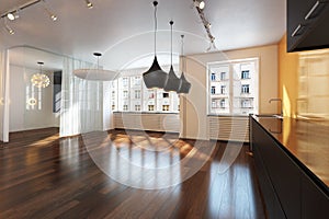 Empty interior residence with hardwood floors .