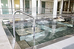 Empty interior swimming pool with relaxation area.