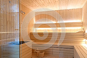 Empty interior of traditional Finnish sauna room. Modern wooden spa therapy cabin with hot dry steam