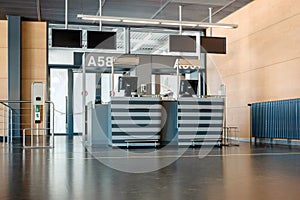 Empty international airport gate front desk with numbered signs in peak season during global pandemic