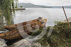 Empty iron boat with unmounted water weeds