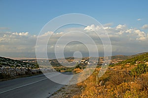 Empty Island Road with Small Village on Hill