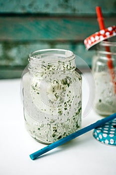 Empty jars with a green cocktail. Conceptual photography. Ending a meal or a veggie party or vacation