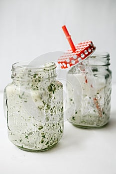 Empty jars with a green cocktail. Conceptual photography. Ending a meal or a veggie party or vacation