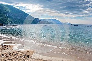 Empty Jaz sandy beach near Budva on the background of a hill