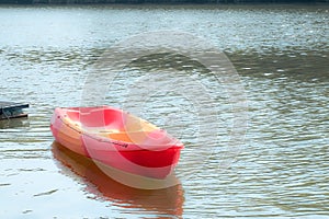 empty kayak on the sea with the forest background.