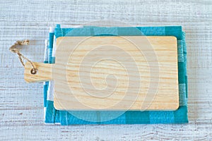 Empty  kitchen cutting board with handle and rustic towel