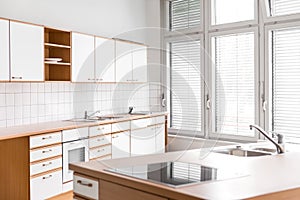 an empty kitchen with windows