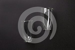 Empty latte glasses on black colored paper background