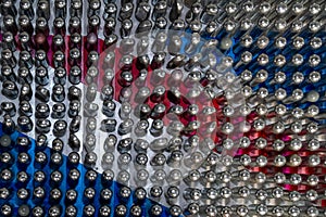 Empty laughing gas canisters reflecting colourful background. These metal cylinders contain nitrous oxide / laughing gas