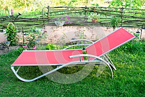 Empty lawn chair, lounge on grass in the garden, backyard in summer vacation