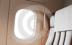 Empty Leather Chair Background Inside Interior First Class Airplane Private Jet. Blank White Illuminator Mockup Ready photo