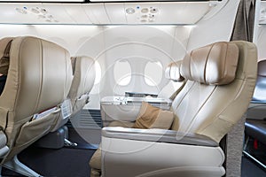 Empty leather seats in row atBusiness class reclined seats of ai