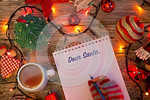 Empty letter for Christmas starting with â€œDear Santaâ€, Christmas background with notebook surrounded by decorations