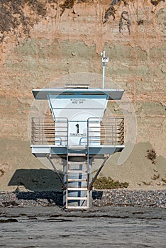 Empty lifeguard tower at beach with mountain in the background