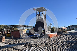 Empty lifeguard tower on a sandy beach.
