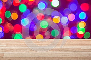 Empty light wood table top with colorful lights bokeh background. Can be used for new year, christmas or any holiday event project