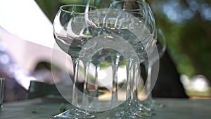 Empty liquor glasses at a picnic. Slow motion