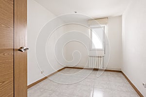 Empty living room with brown baseboard, aluminum window