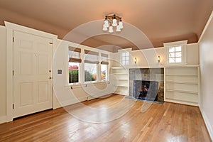 Empty living room interior with mocha ceiling and tile trim fireplace