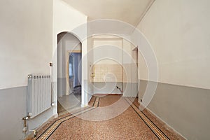 Empty living room and kitchen area interior with tiled floor