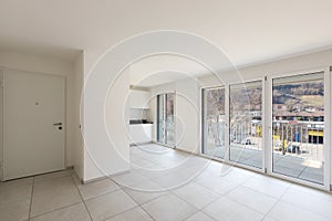 Empty living room with large windows