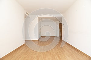 Empty living room with light wood flooring, ducted air conditioning photo